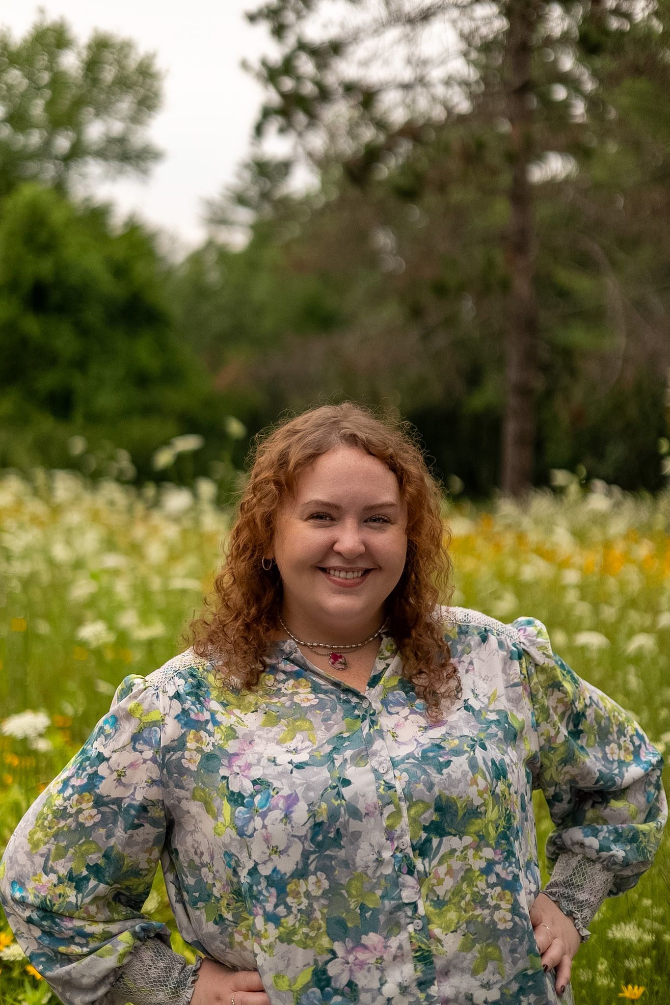 Woman smiling for a portrait in a field of flowers