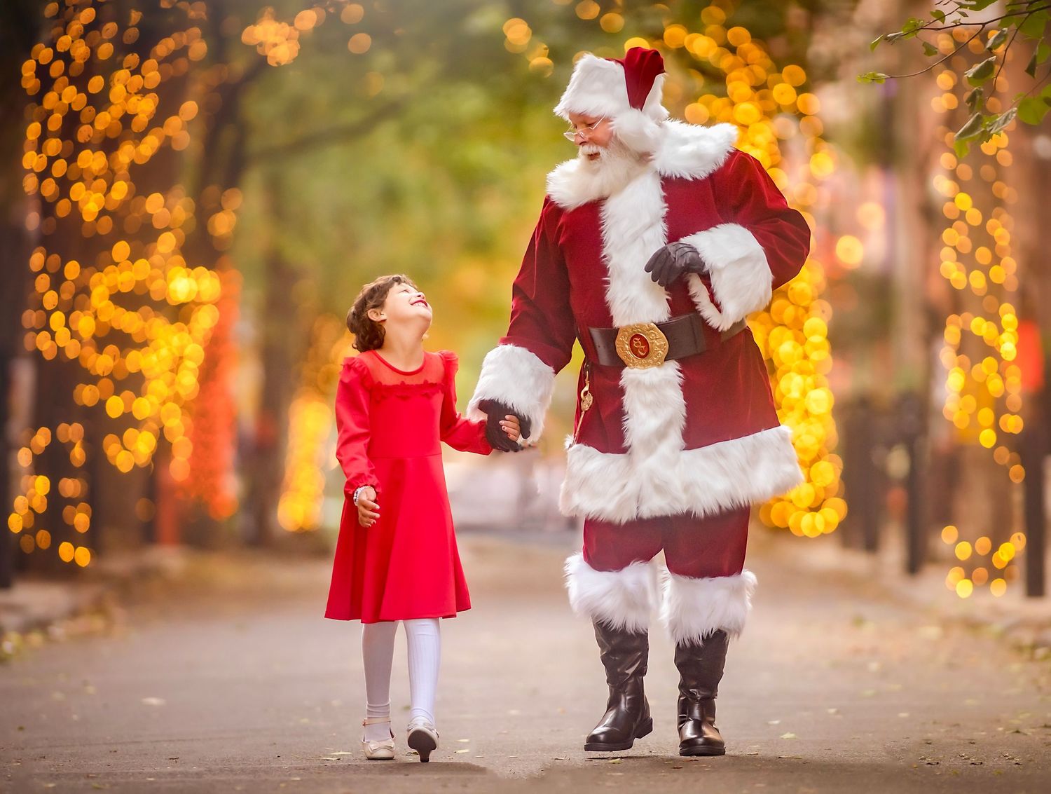 Santa and young girl celebrating Christmas together during a festive South Jersey photo session.