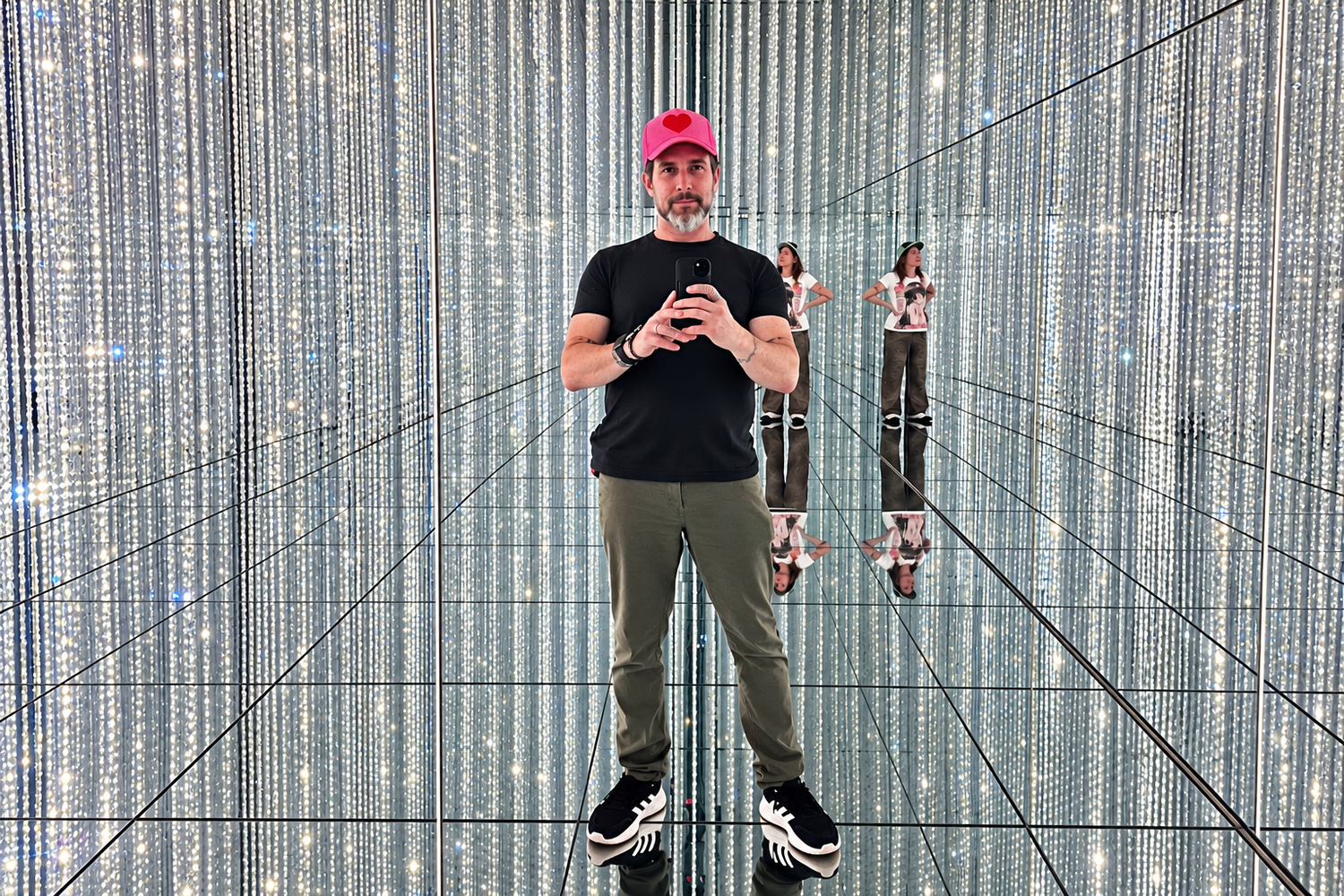 Male photographer holding phone and taking a selfie