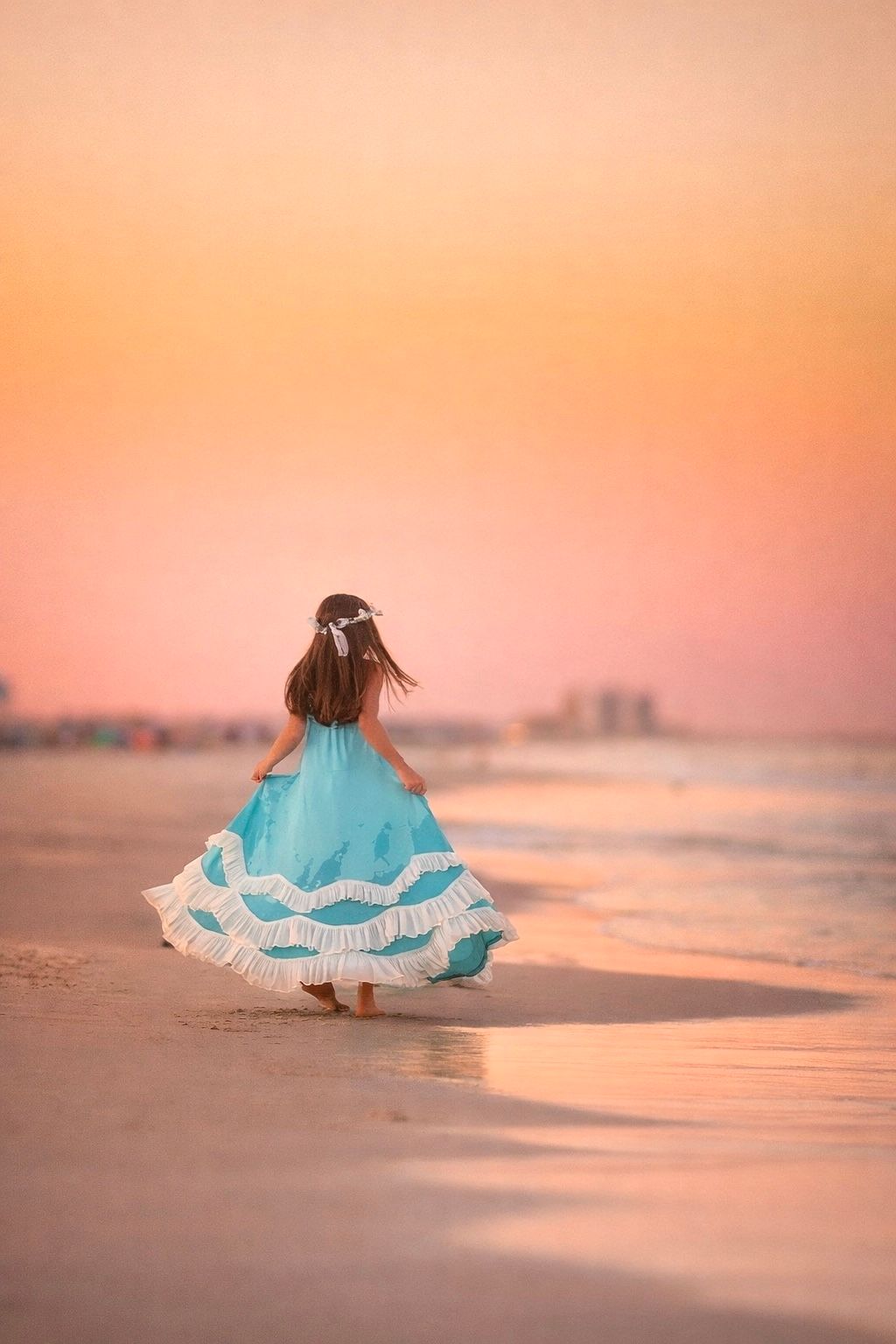 Young girl dressed in blue during a beach portrait session in Sea Isle City, New Jersey.