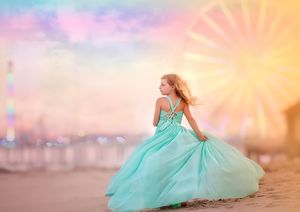 Young girl wearing blue during a beach portrait photography session in Atlantic City, New Jersey.