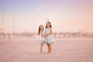 Two young girls enjoying a beach photography session in Atlantic City, New Jersey.