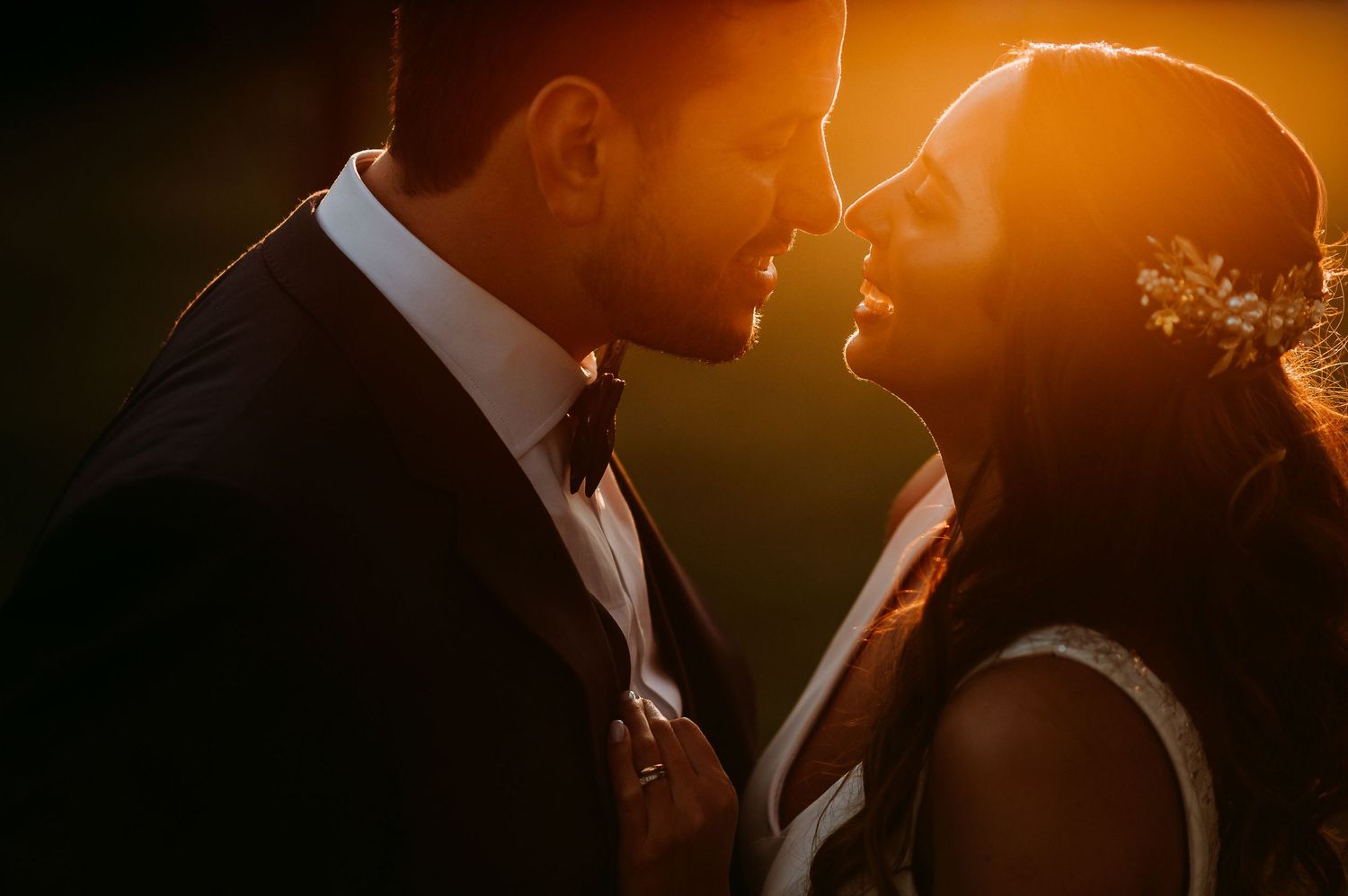 Bride and groom sharing an intimate moment, touching foreheads on their wedding day.