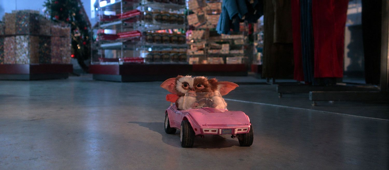 Gizmo driving his pink Corvette in Gremlins