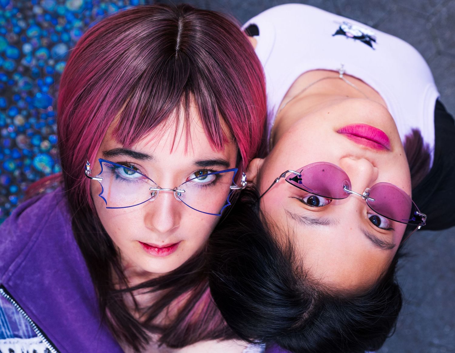 Mei and Mary from Doll Parade wearing glasses from the Lens Alter x Sanrio Collab. Mei wears the bats glasses and Mary wears the Kuromi ones