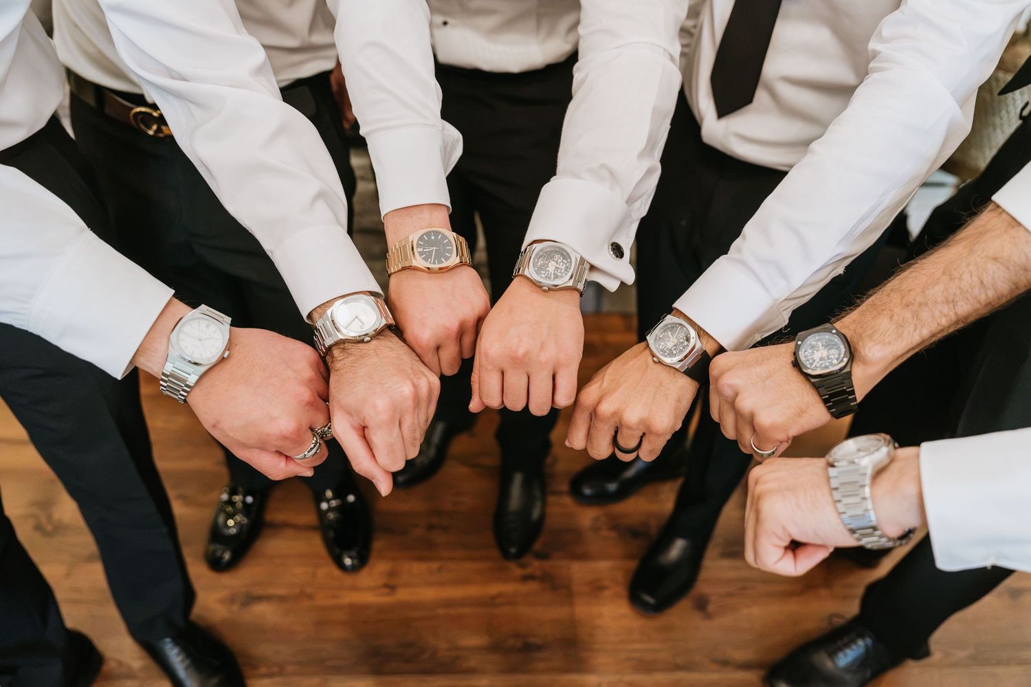 Groom and groomsmen showing their watches before the ceremony