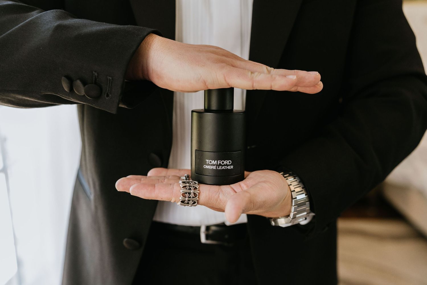Paul applying cologne while getting ready for the wedding
