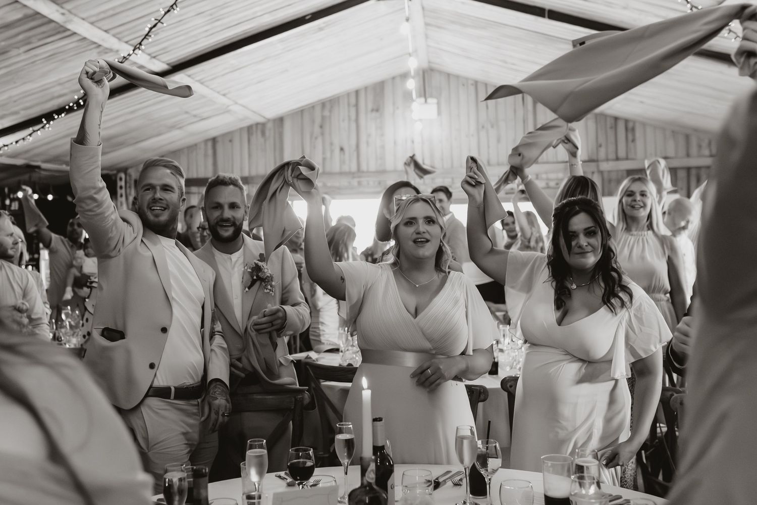 Black and white photo of wedding guests celebrating,