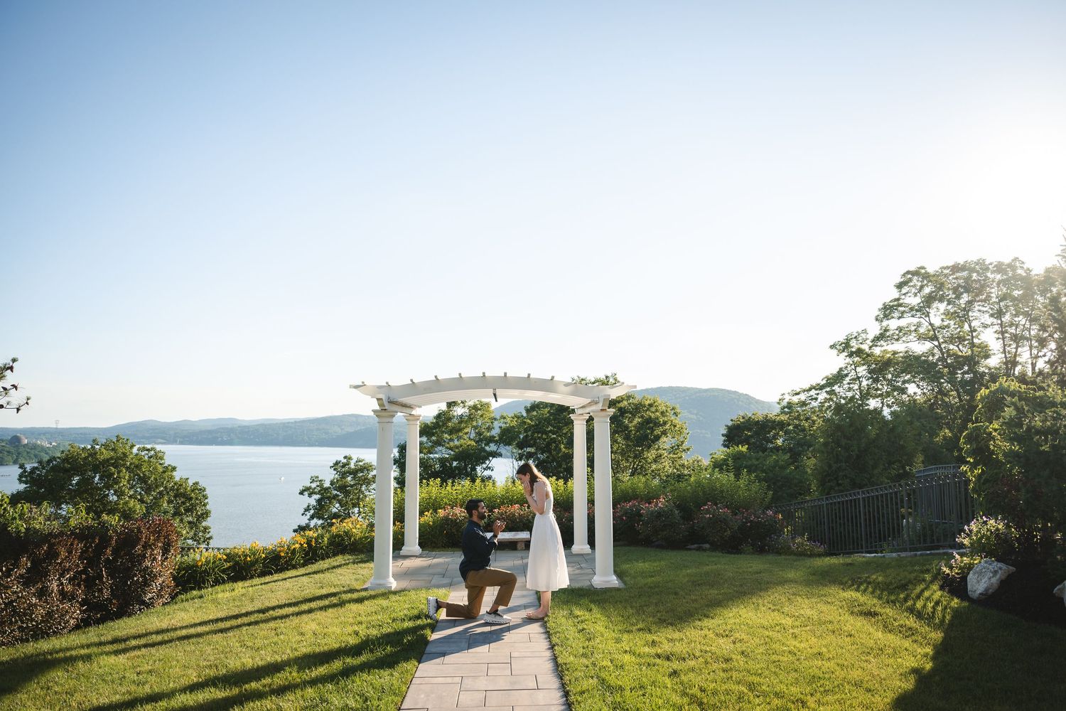 Bride in long elegant white dress walking down stairs with flowers at Ruins at Sassafras wedding venue New Lebanon NY in Hudson Valley
