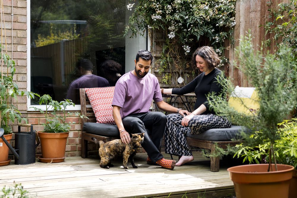 couple sitting on patio in their back garden in hackney