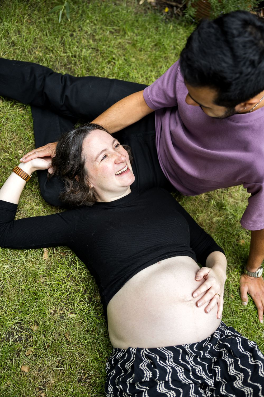 pregnant woman laying on grass in east london