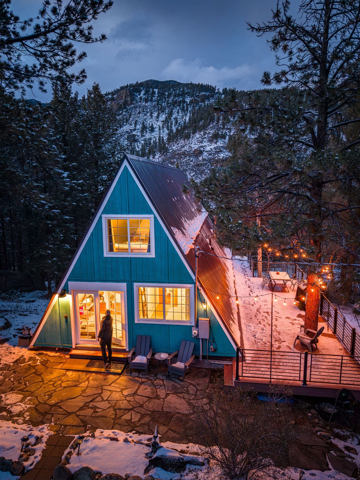 Aerial/drone night shot of a vacation rental property, The Hygge Chalet with snow in Grant, CO.