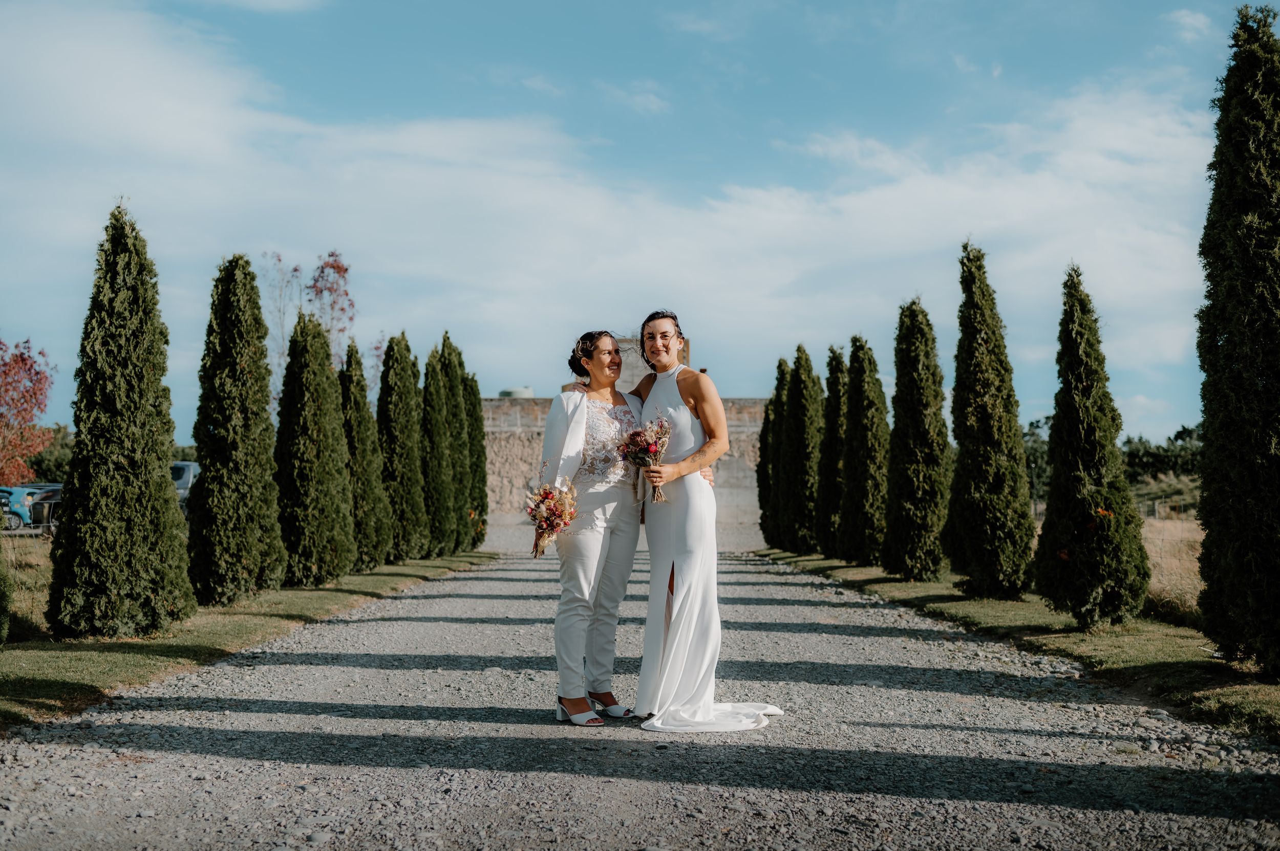 Lily and Kayla smiling together at their Laxmill Wedding Venue celebration in Christchurch.