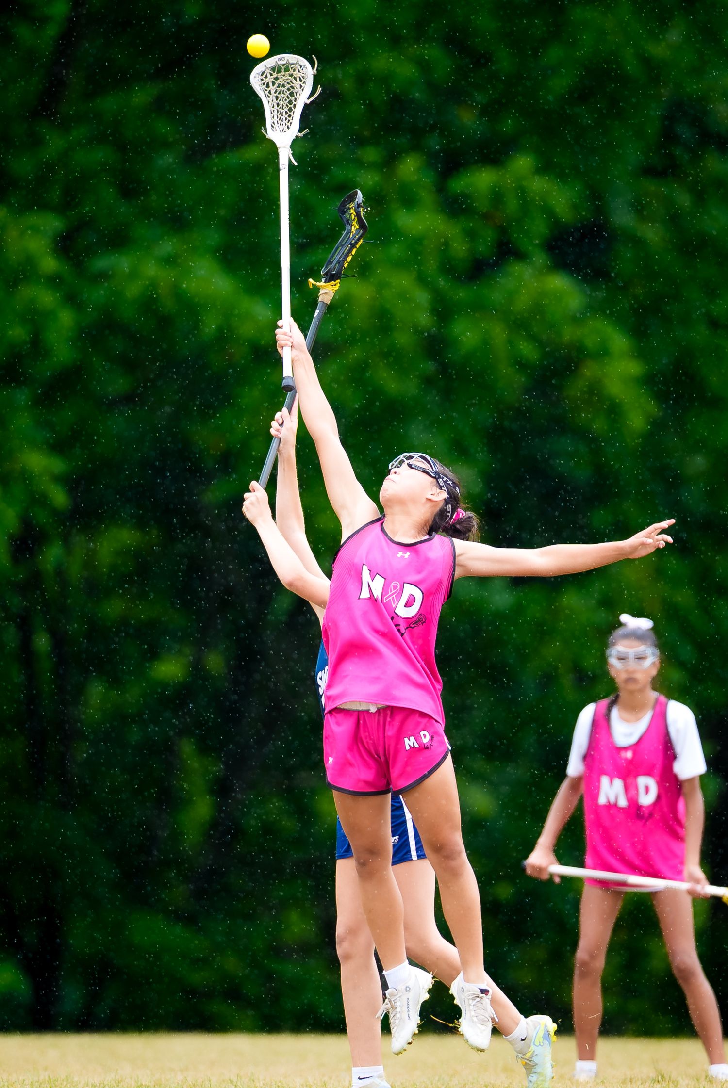 M&D Black 2031 girls lacrosse player reaching for a high ball at Summer Genesis, by Deanna Fox, SportsFox Photography based in Hershey PA