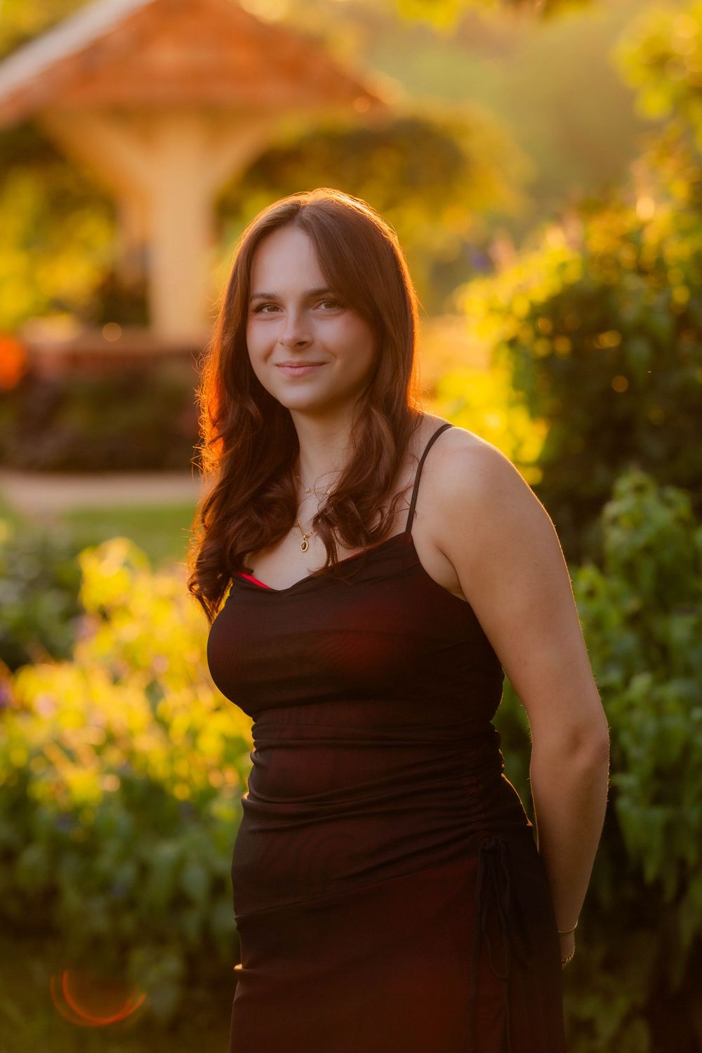 A portrait in golden sunlight against blurred yellow foliage in warm autumn evening lighting.