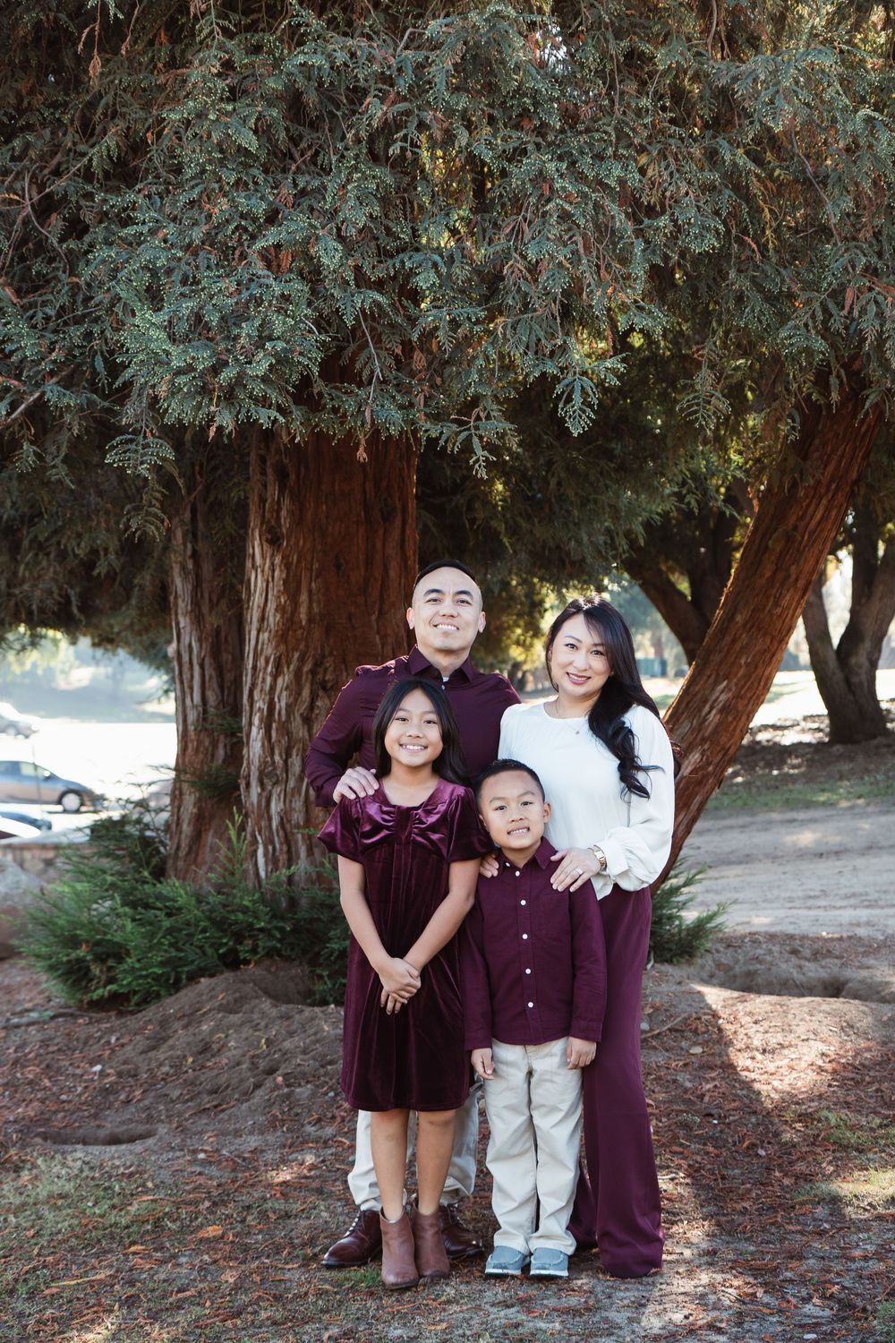 Outdoor family portrait with coordinated outfits in Fresno, California for holiday postcard