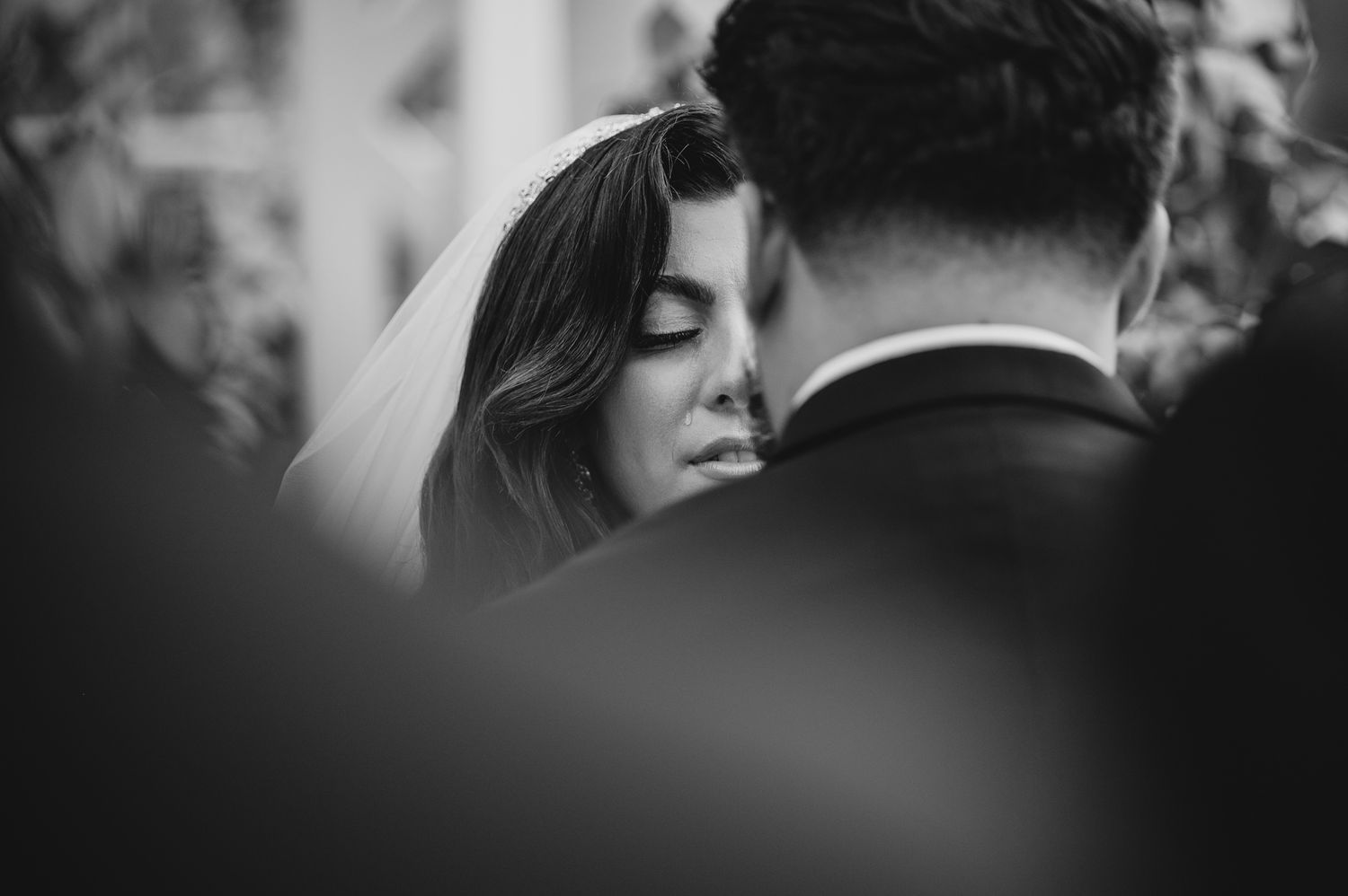 Black and white photo series showing intimate wedding moments and romantic embraces between a couple.