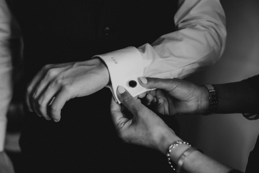 Black and white close-up images show hands performing various actions with a camera and film equipment.