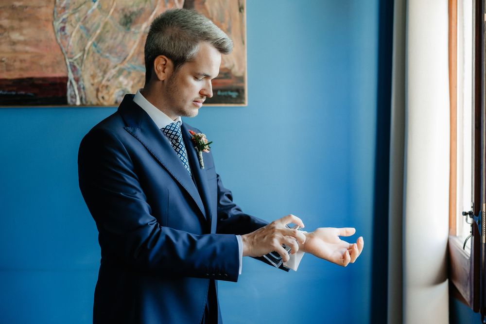 A series of photos showing two people in suits hugging against a blue wall background.
