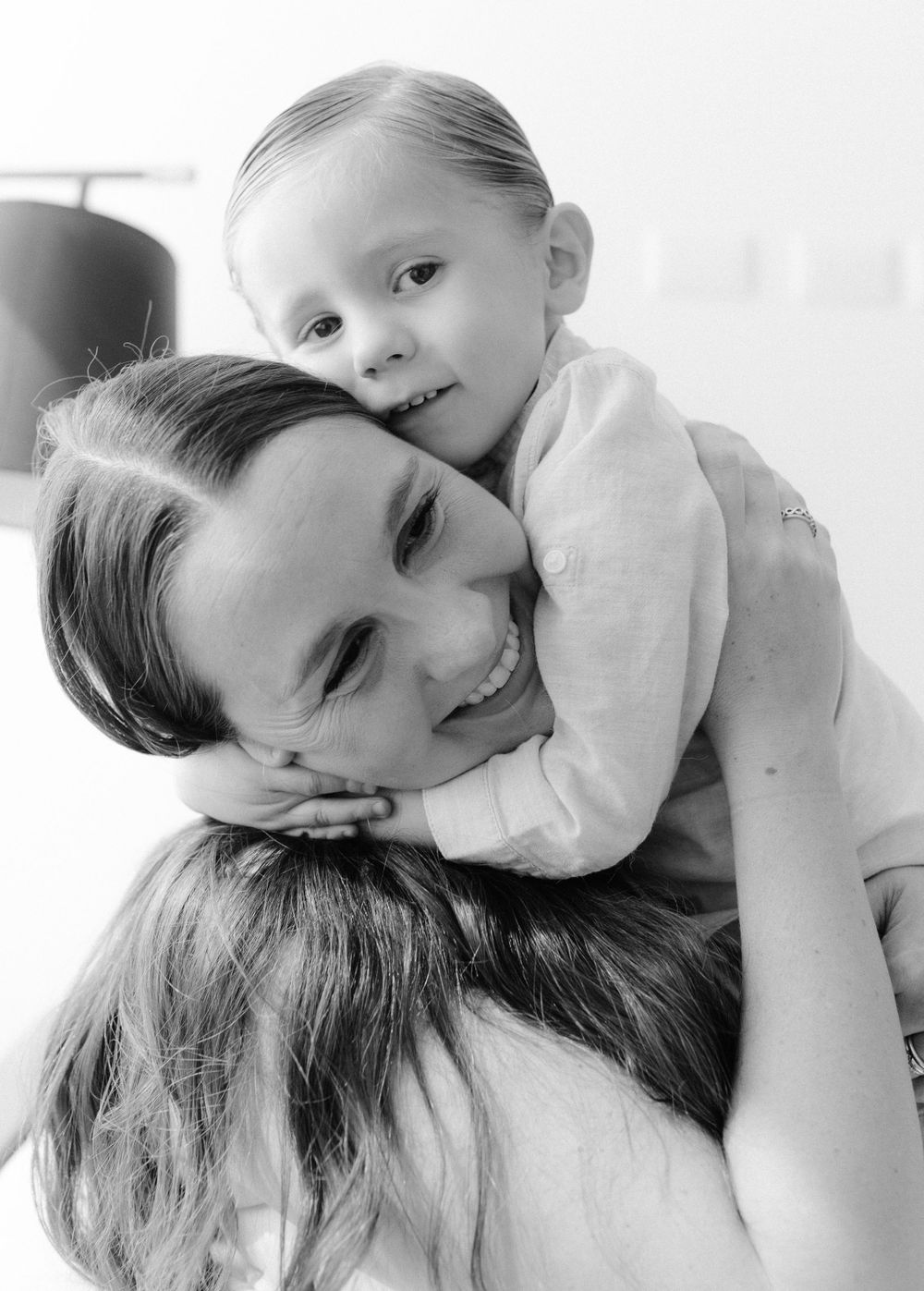 A touching black and white portrait showing a tender moment of familial affection.