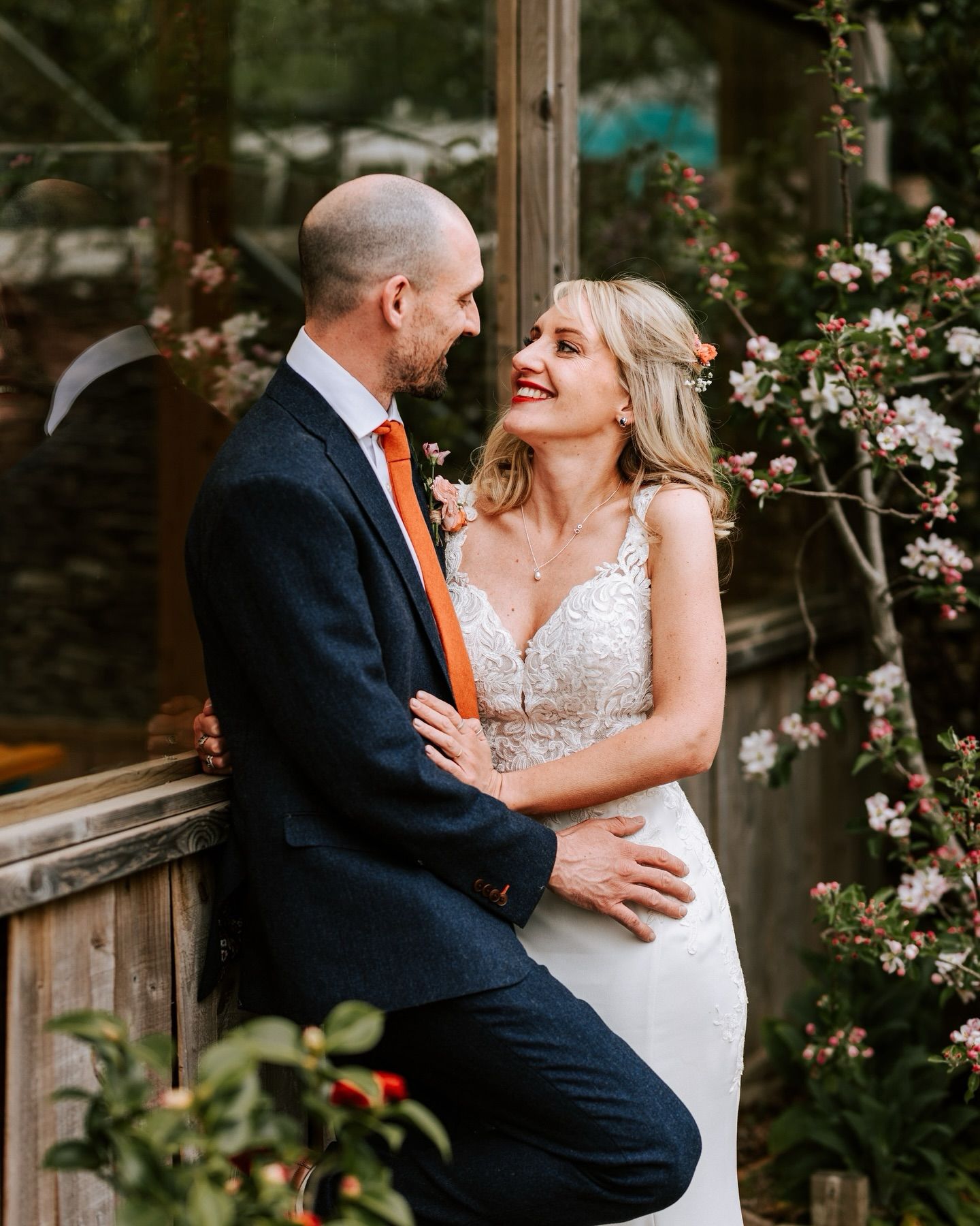 A romantic wedding photography series showing a couple sharing intimate moments in a garden setting.