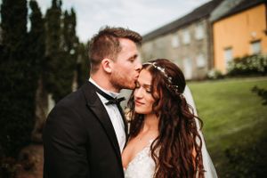 An intimate wedding portrait captured outside a historic building.