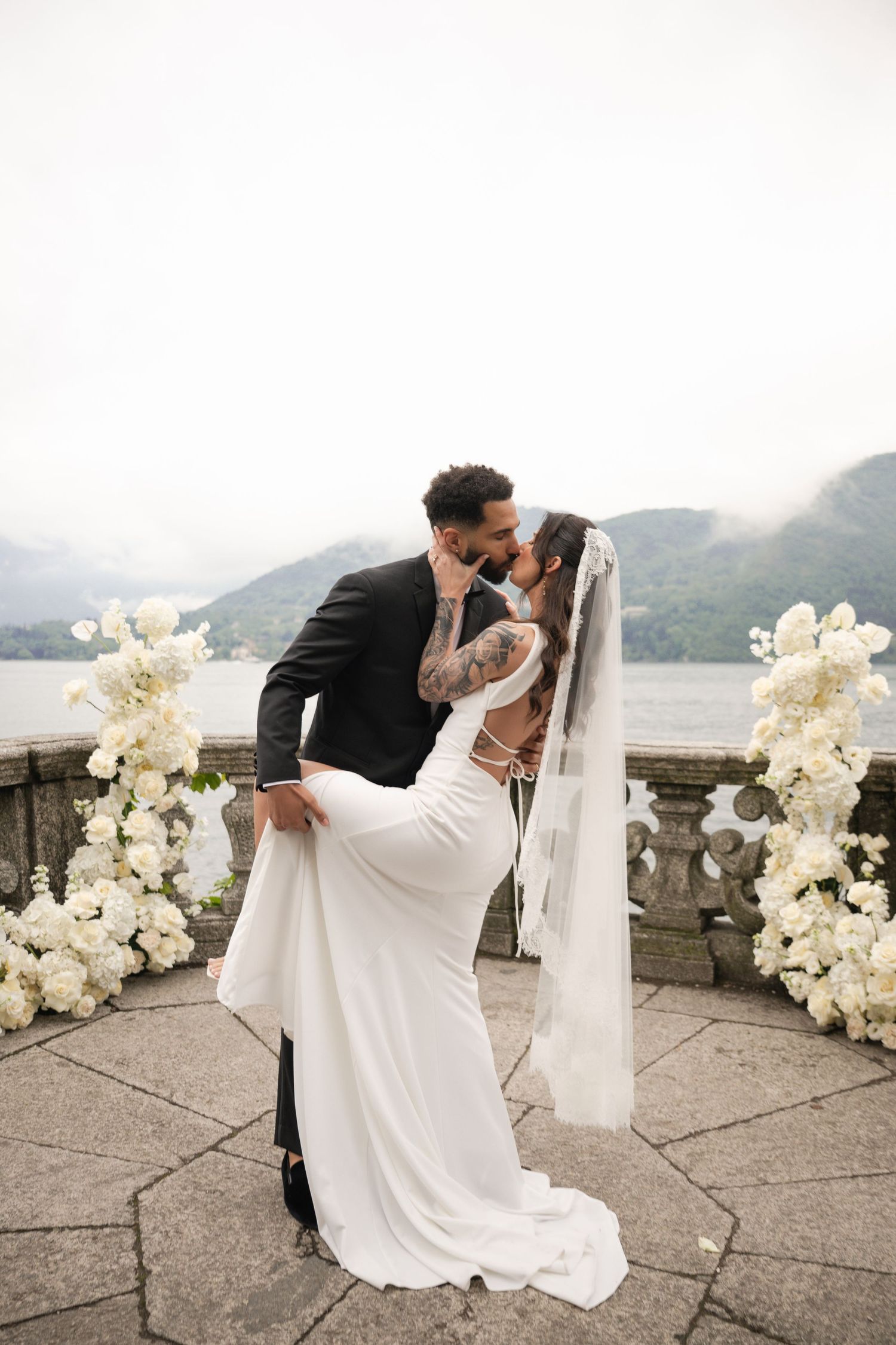 Romantic wedding portrait overlooking scenic Positano coastline in Italy.