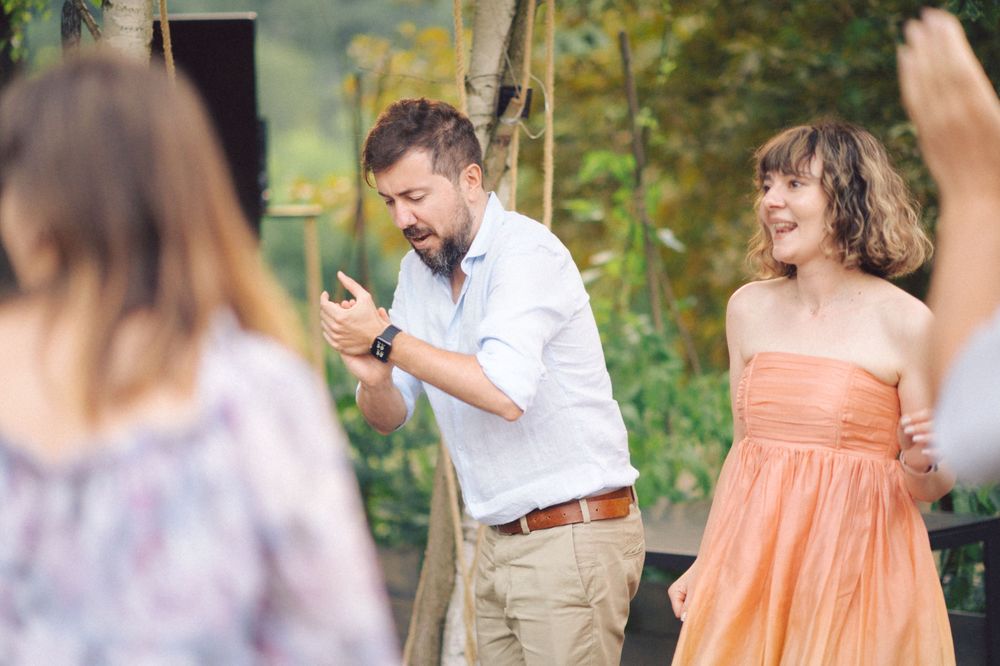 Guests enjoying themselves at an outdoor celebration in summer attire.