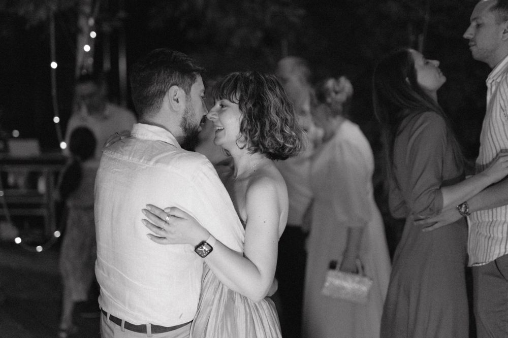 Couples dancing together at an evening wedding reception.