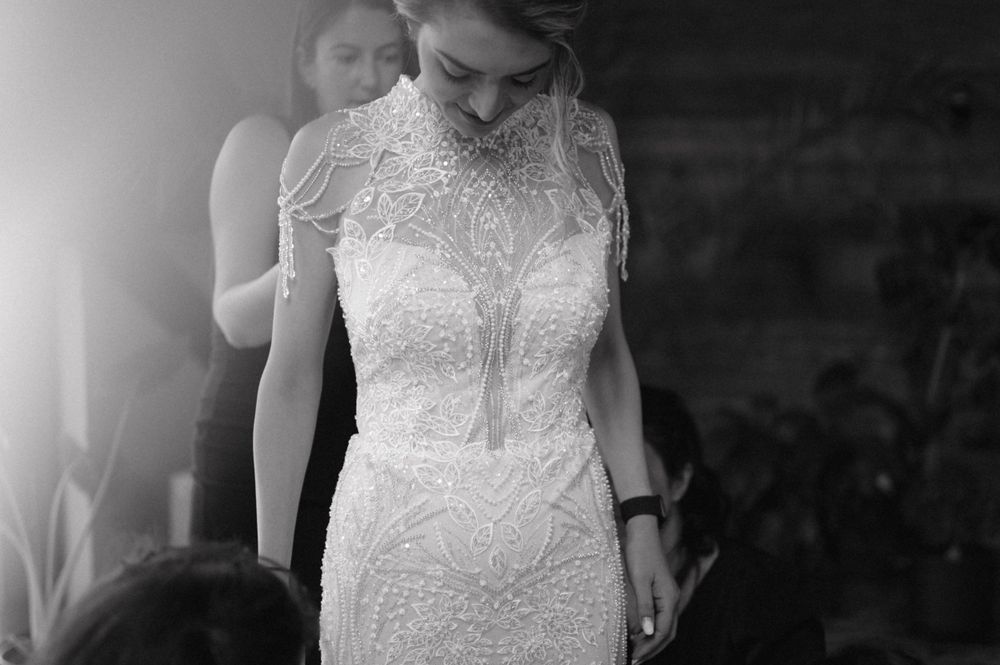 Black and white image showcasing the detailed bodice of a fitted wedding gown.