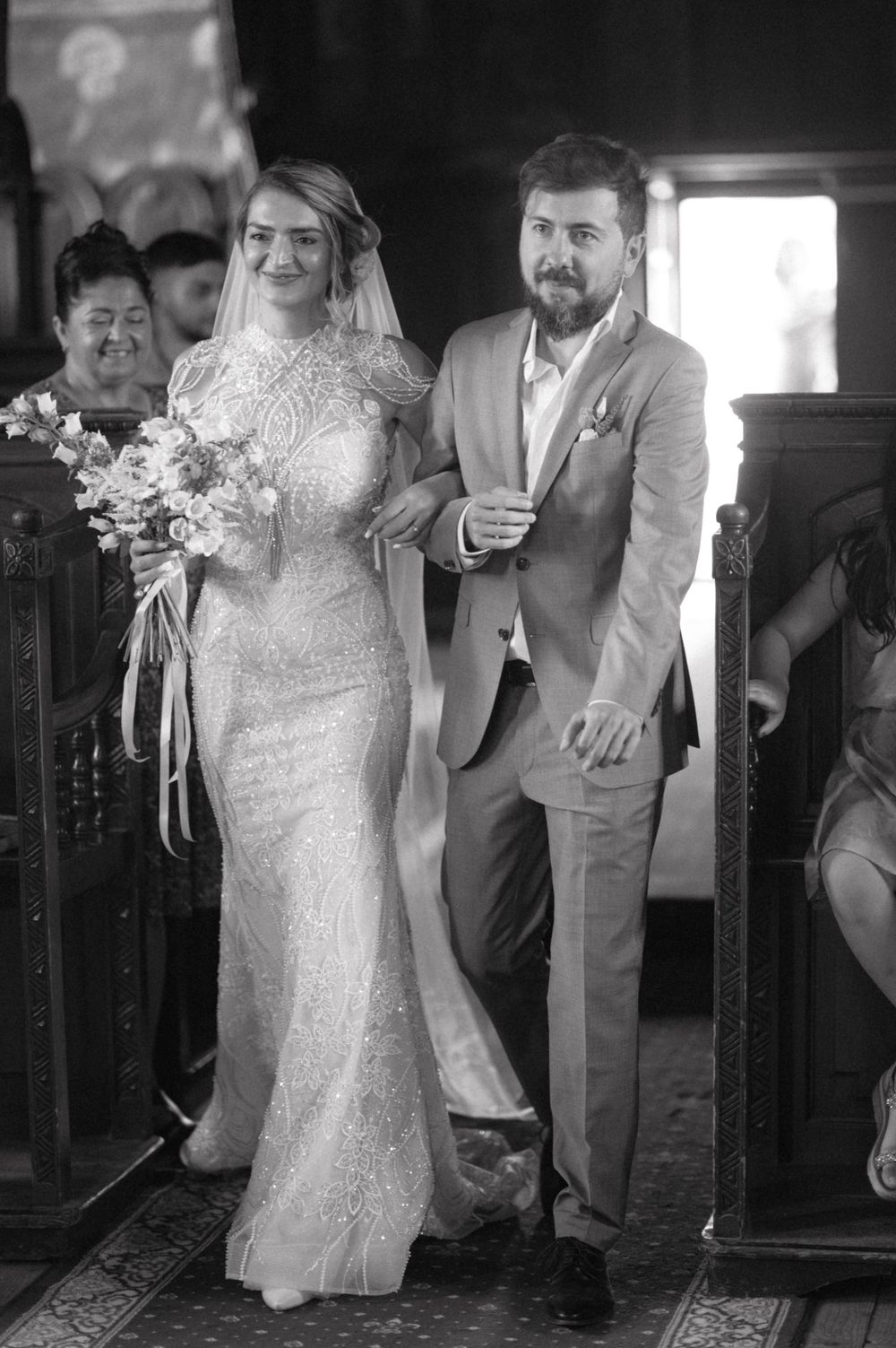 Black and white wedding ceremony photo capturing a couple at the altar.