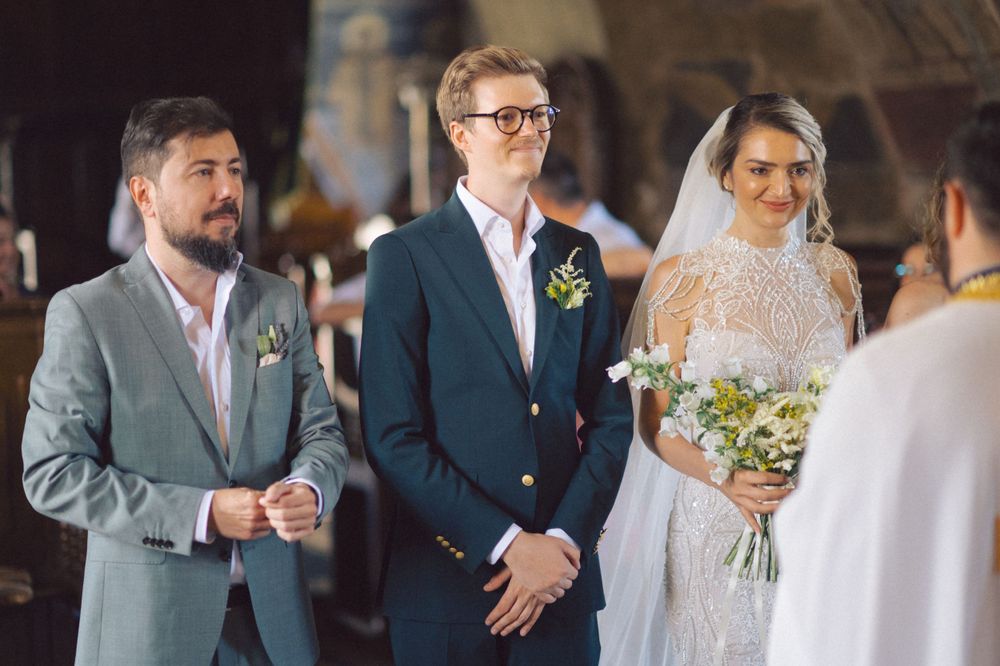 Wedding ceremony at the altar with three attendants in formal attire.