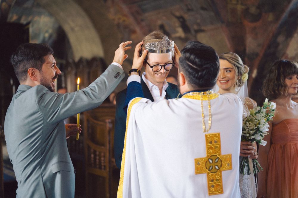 An Orthodox priest performs a ceremonial blessing during a traditional wedding service.