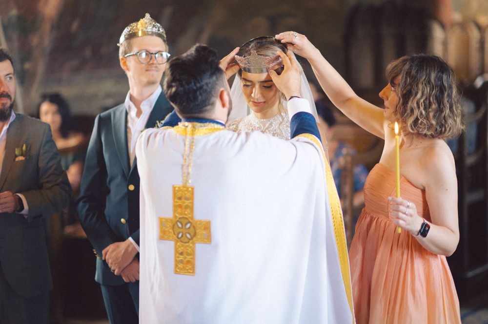A traditional Orthodox wedding blessing ceremony takes place in an ornate church.