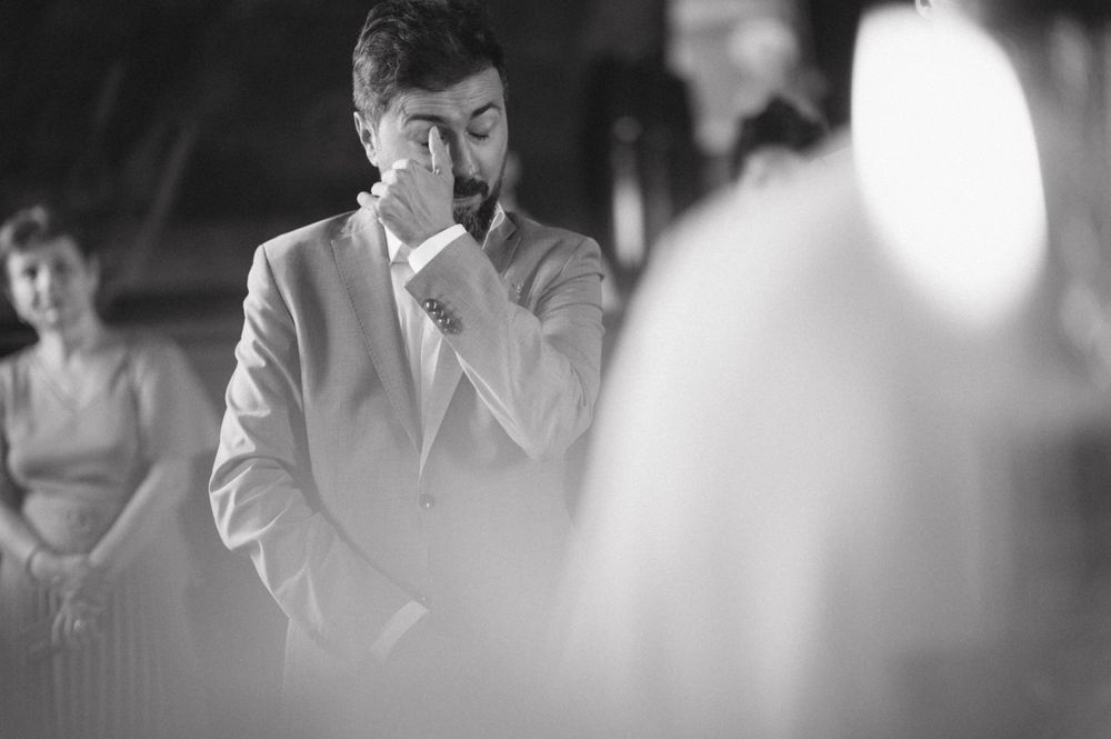 Emotional black and white candid moment during wedding ceremony.