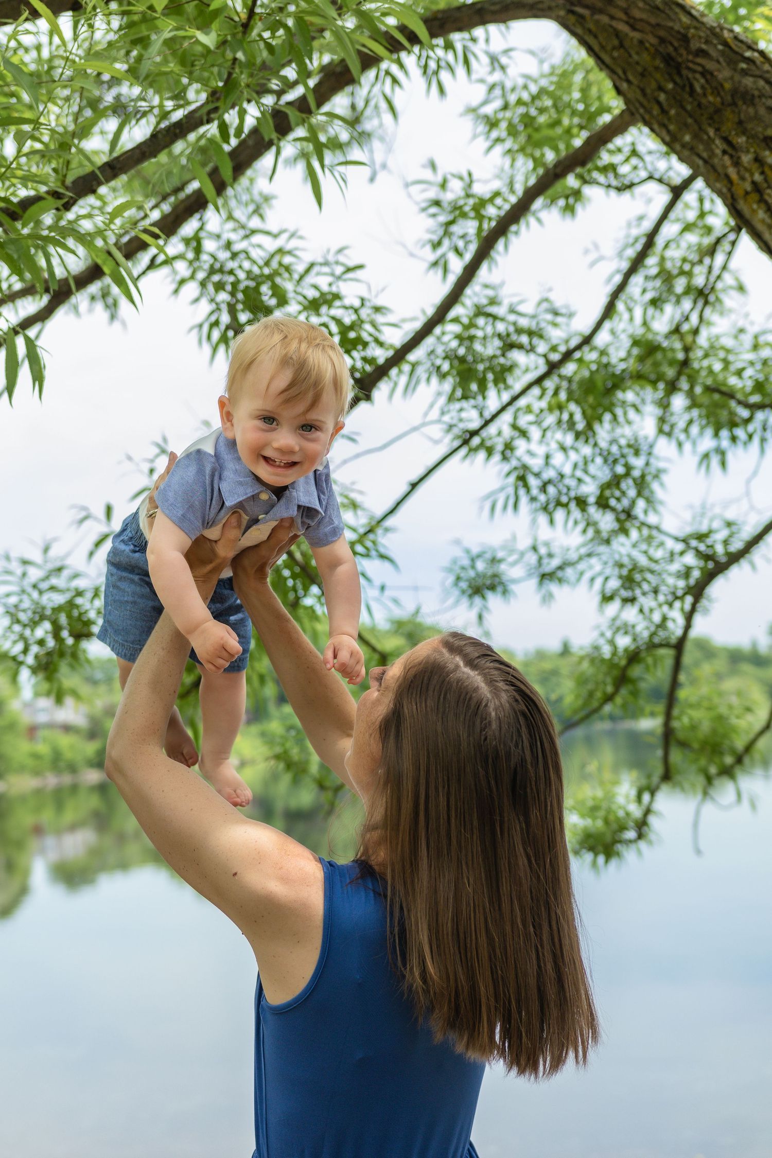 Mother Ashley holding her child during a tender motherhood photography session.