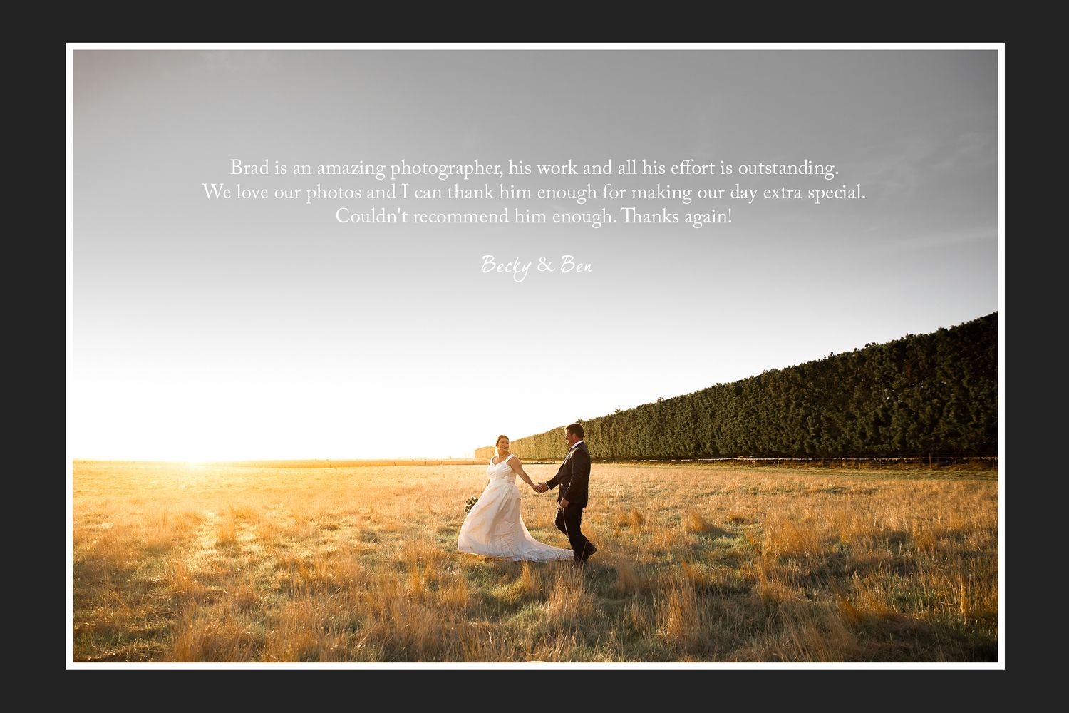 A couple dances in a golden field at sunset with mountains in background.