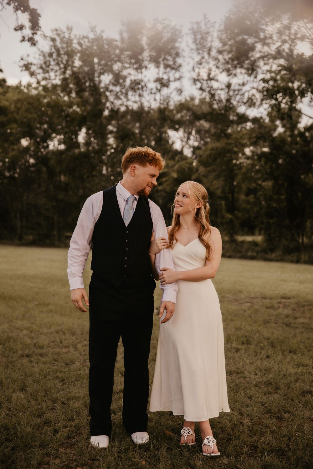 A romantic outdoor wedding photoshoot sequence of a couple in formal attire sharing intimate moments at sunset.