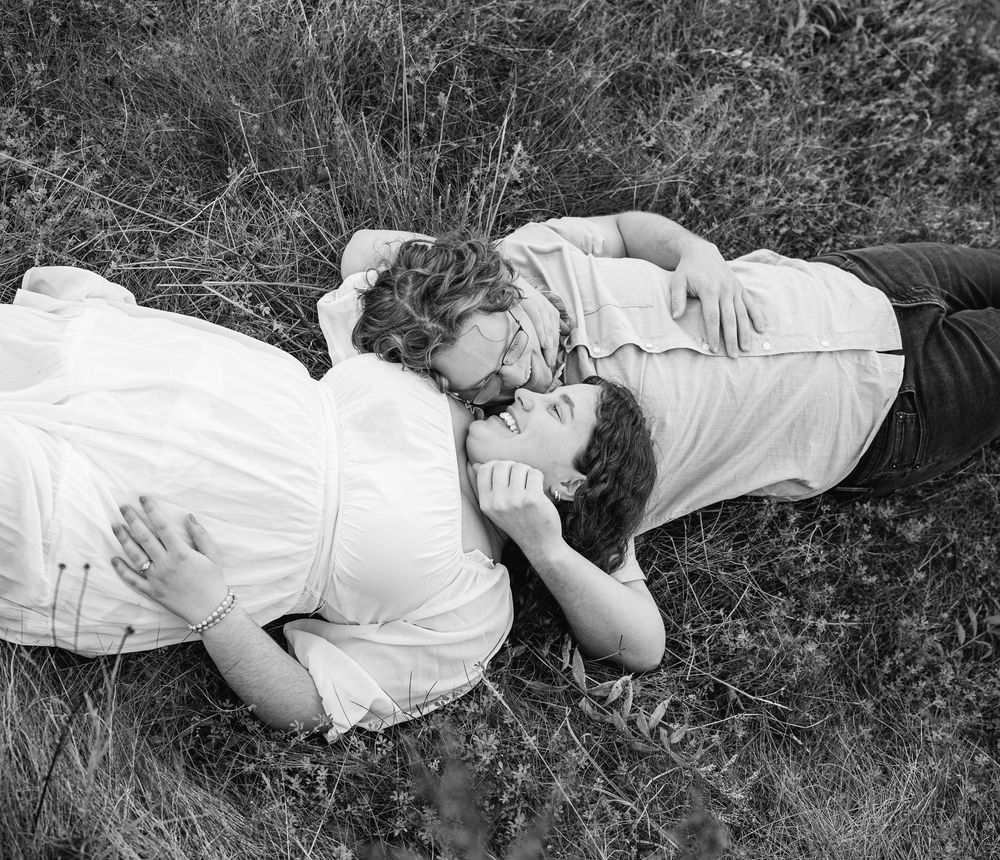 Black and white photo series of a couple lying in grass together.