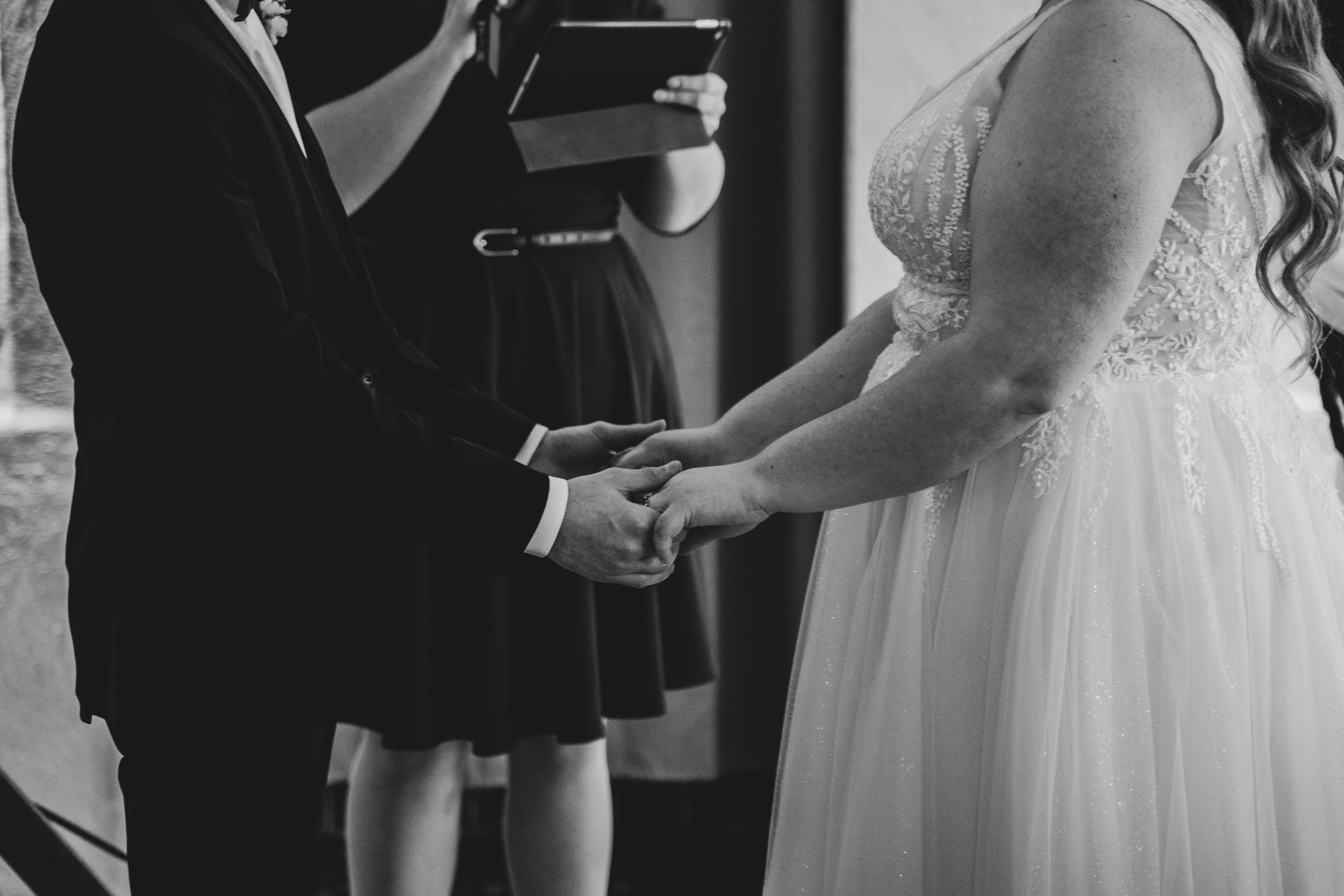 Black and white candid moments captured during wedding reception.