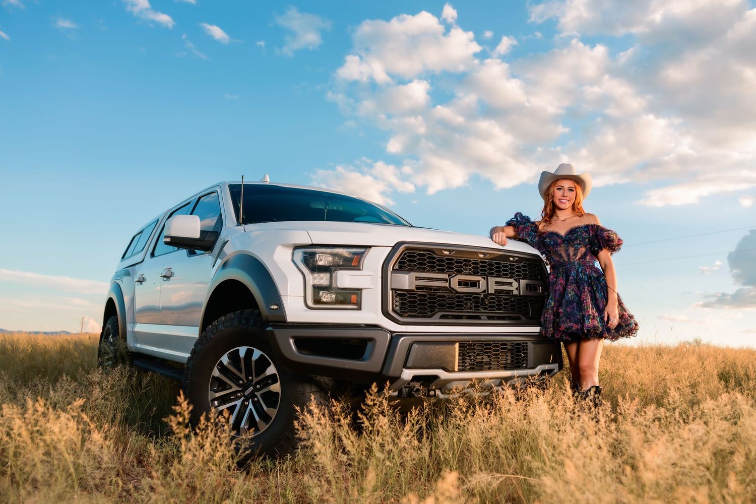 High school senior girl with truck in a field in Tucson, photographed by Tucson Senior Photographer