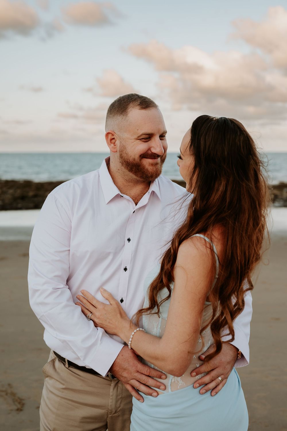 Romantic tannum sands beach photoshoot with couple in white shirt and mint dress.
