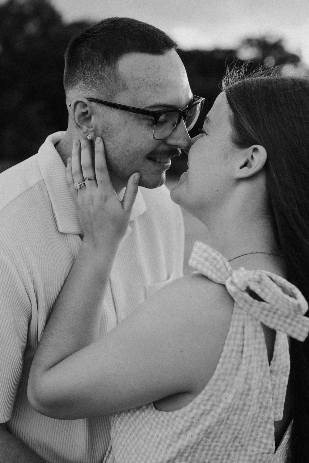 Black and white close-up of couple sharing an intimate moment.
