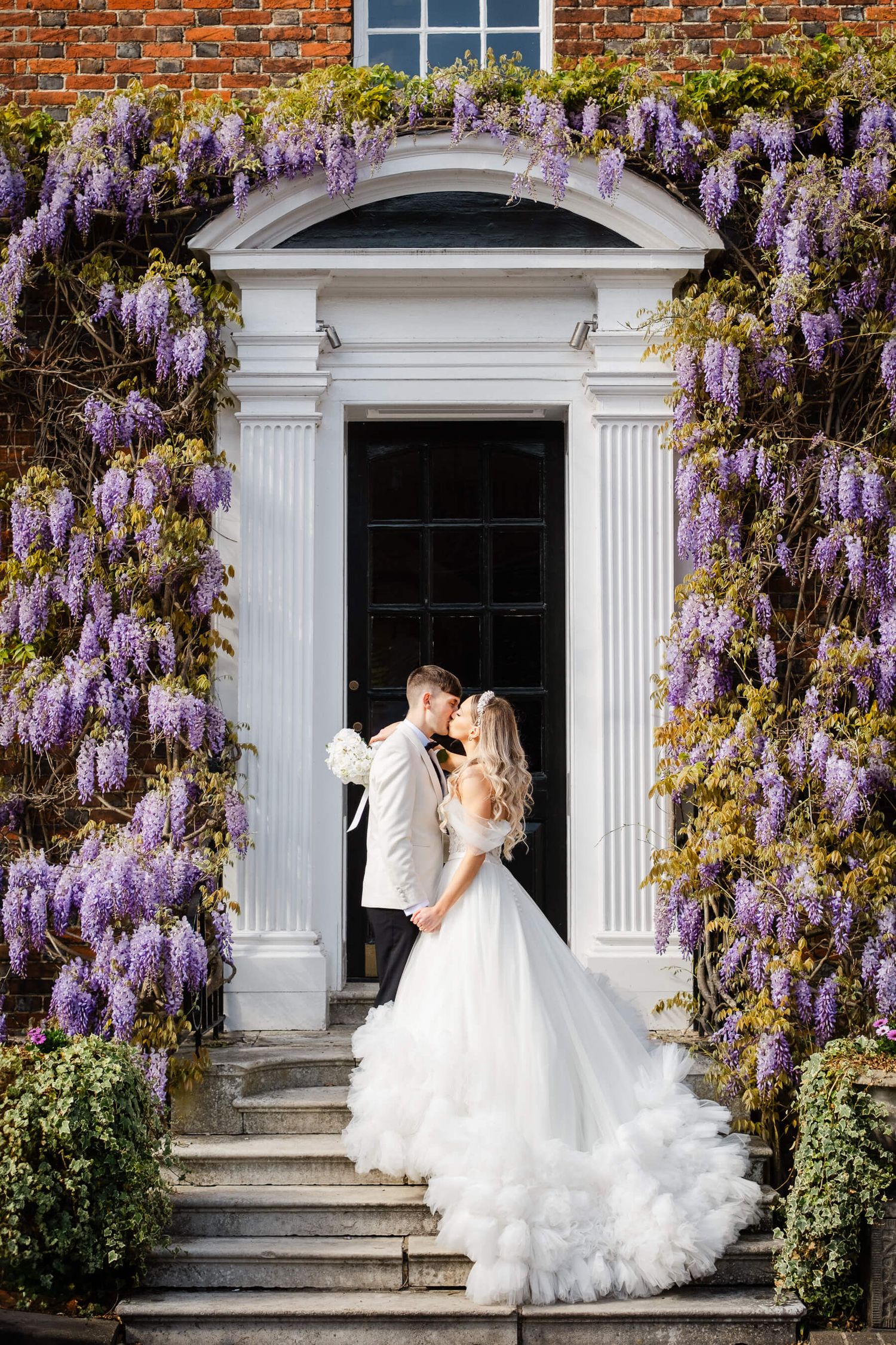 Bride and groom kissing at wedding at the Orangery In Maidstone