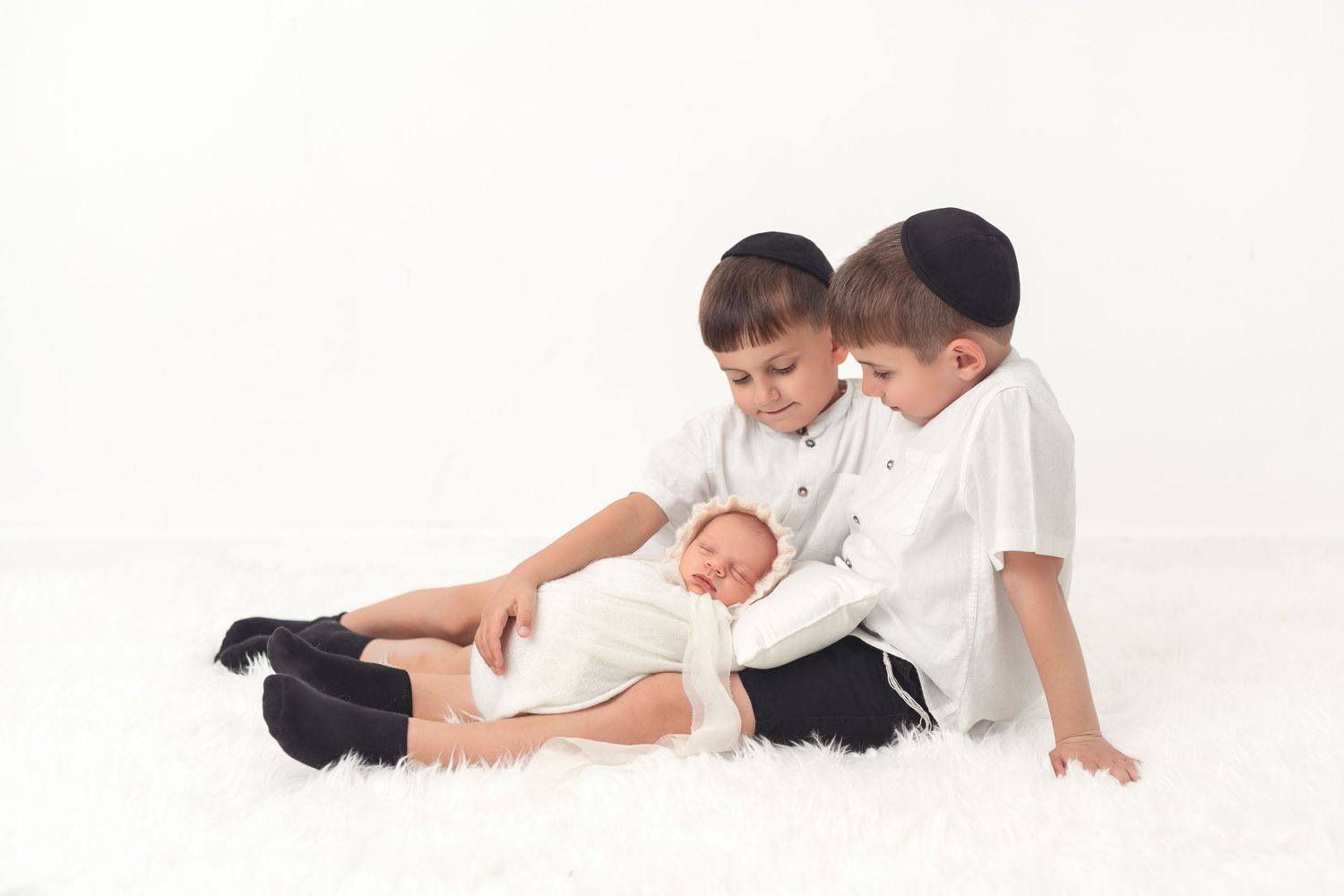 A sequence of black and white photos shows different poses of parent and child playing together on a white background.