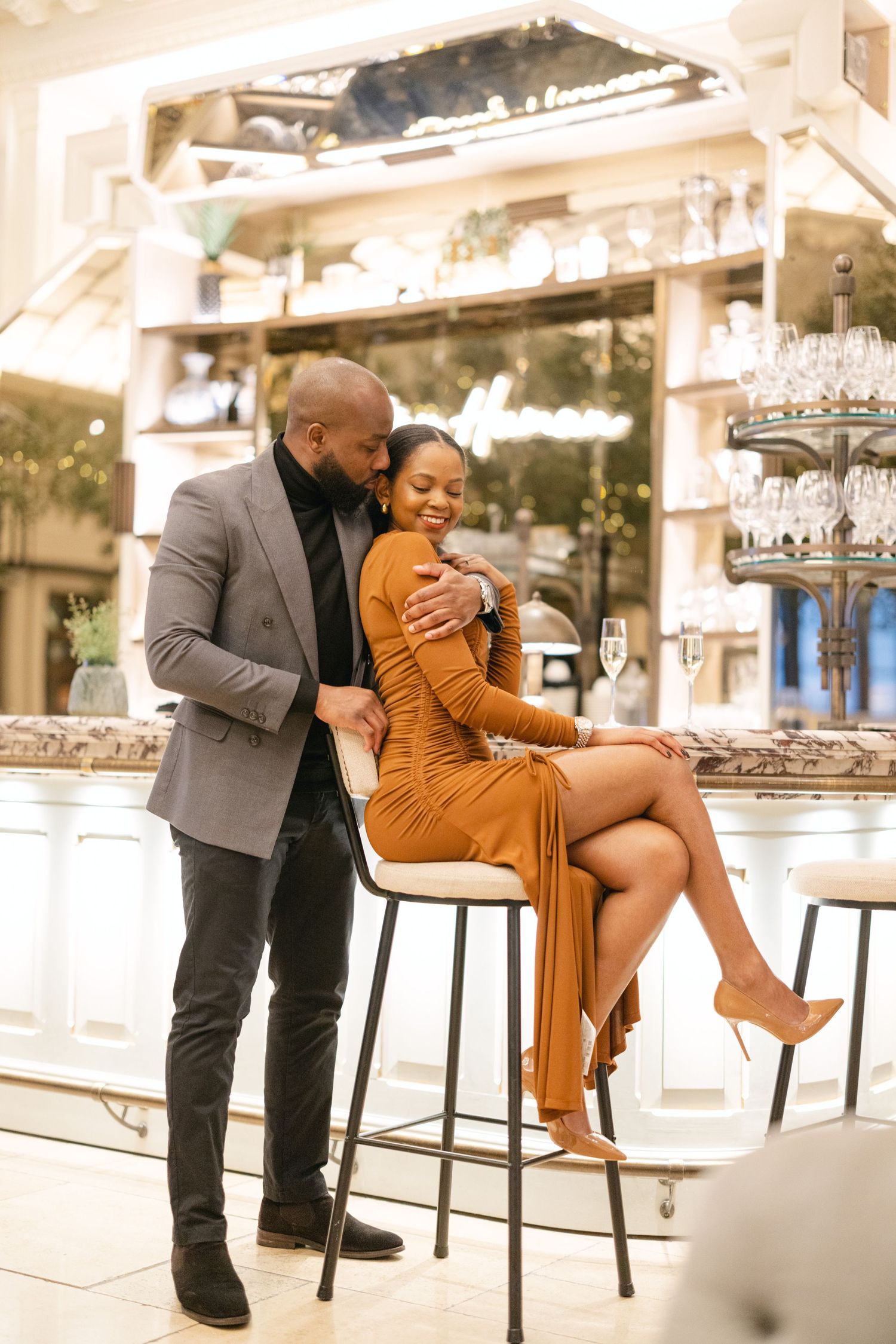 Couple sharing an intimate moment at an elegant bar setting.