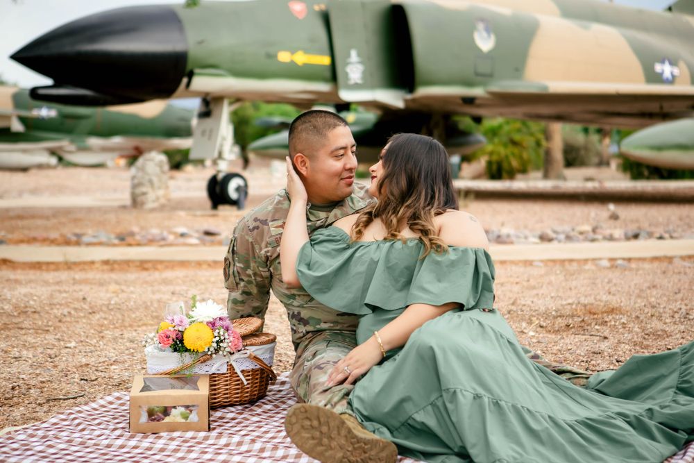 Romantic picnic scene with vintage military aircraft in the background.