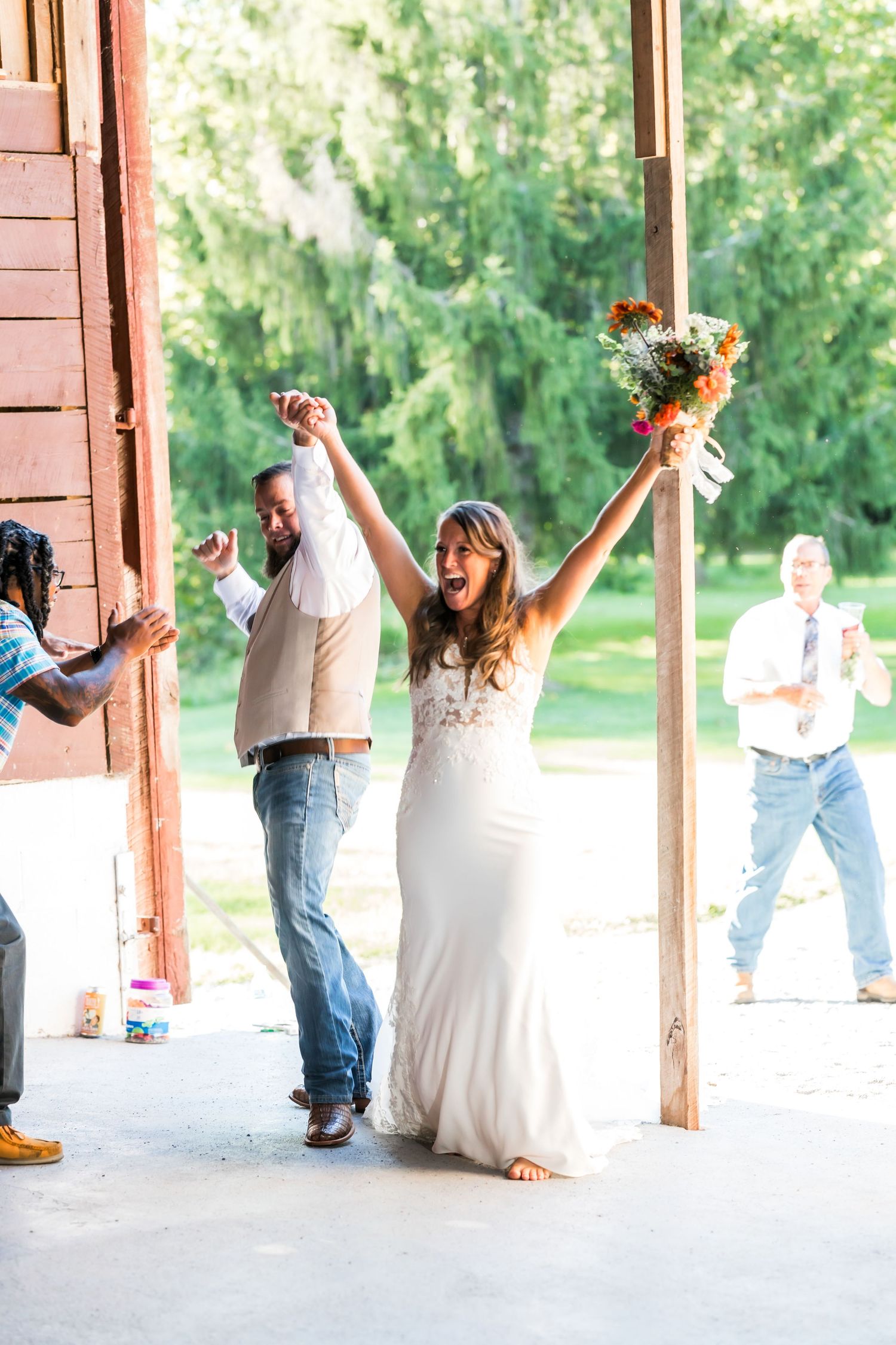 Wedding table decor featuring wooden arch with crystal drops and blush roses.