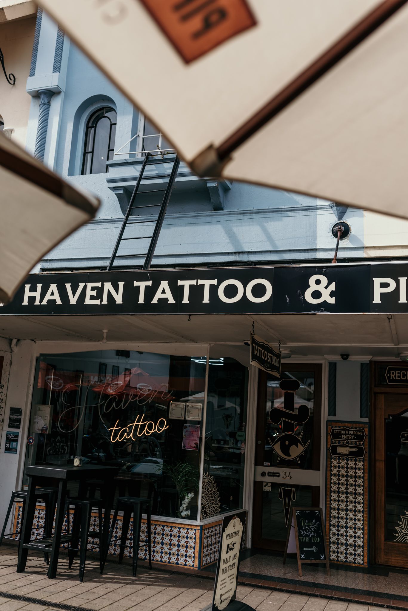 Exterior view of Haven Tattoo shop storefront with traditional signage in Christchurch.