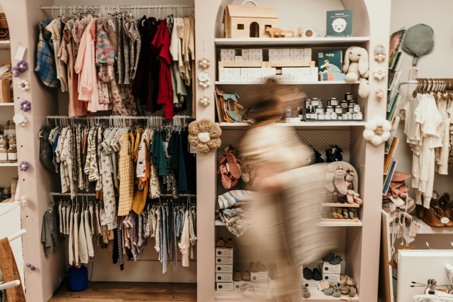Organized closet space with clothing racks and shelving units displaying various garments in Christchurch shop.